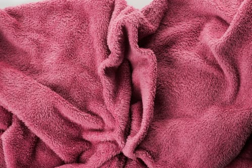 pink-colored towel shaped like female genitalia